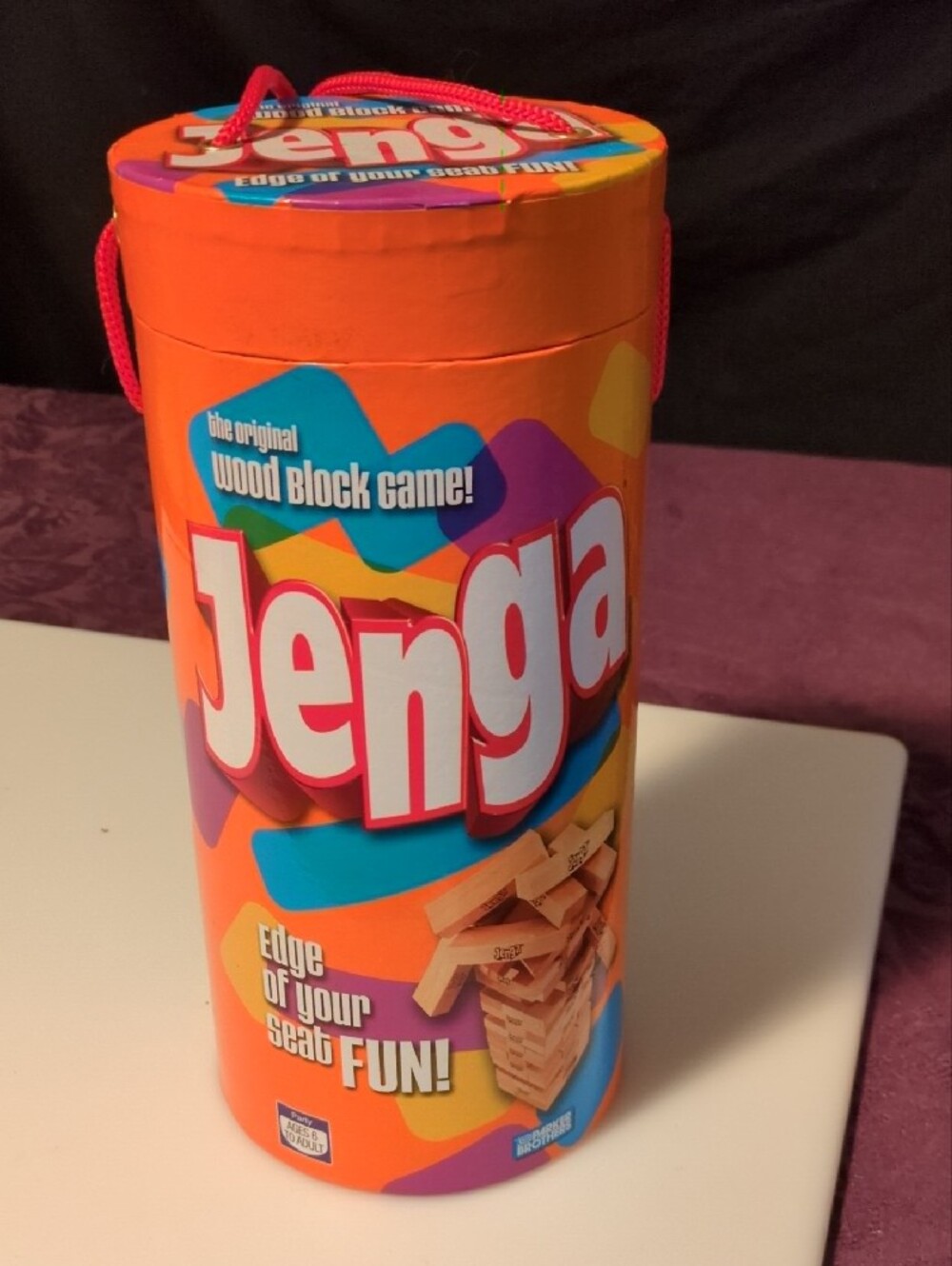 Hasbro Jenga Wooden Block Game - Orange Multicolor Tube- Tan Wooden Blocks